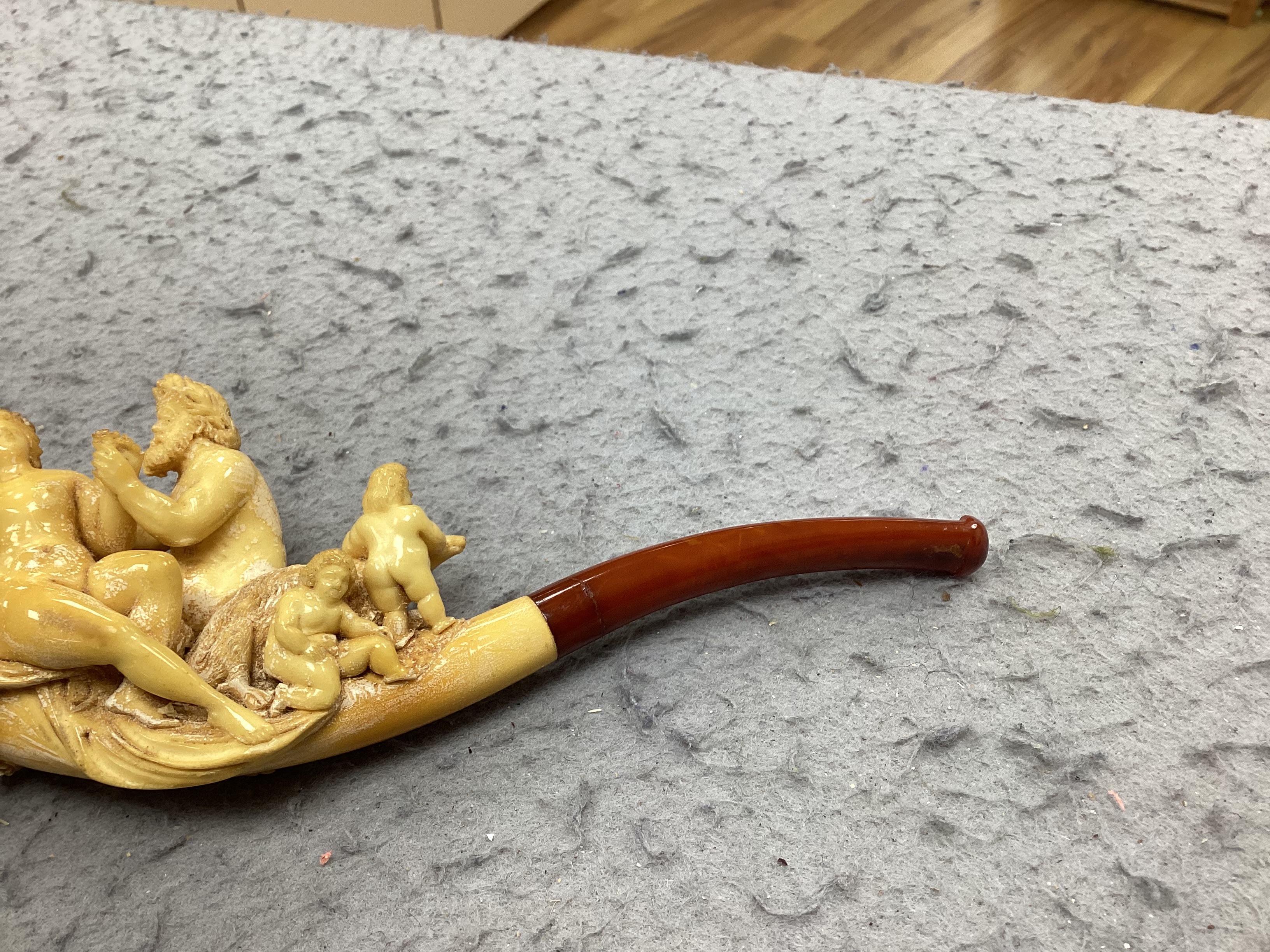 A cased ornate Meerschaum pipe, early 20th century, intricately carved with the figures of Mars and Rhea Silvia with Romulus and Remus and the wolf on the bowl, 18cm long